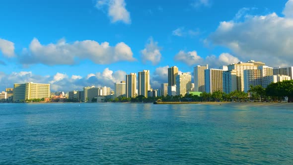 City from the ocean. Tall buildings on Waikiki Beach in Oahu. Skyscrapers on Hawaiian shoreline. alt