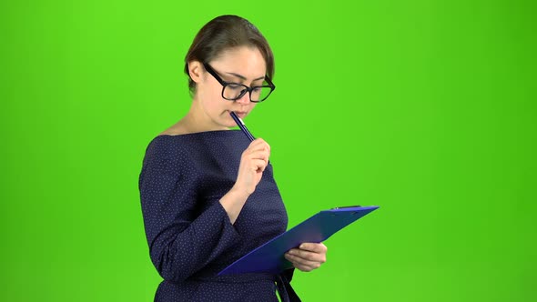 Accountant Records the Data in a Paper Tablet. Green Screen alt