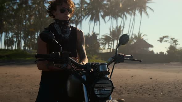 Biker on His Motorbike in Tropics alt