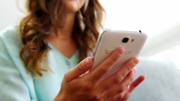 Beautiful woman using mobile phone alt