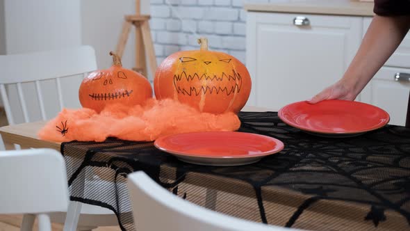 Woman Setting the Table for Halloween Party alt