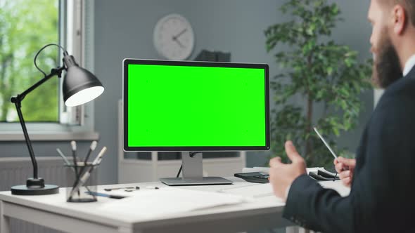 Man at Offiice with Green Screen Pc