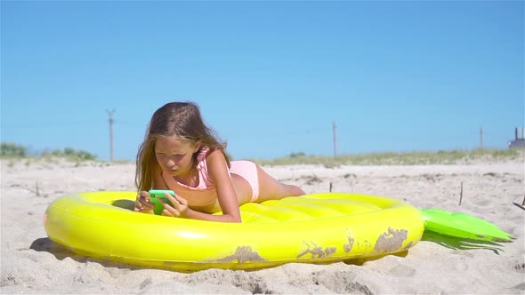 Adorable Girl on Inflatable Air Mattress in the Sea alt