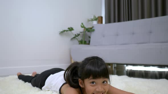 Asian lovely girl in plank pose on carpet in living room alt