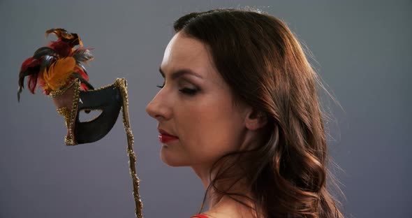 Portrait of beautiful woman wearing masquerade mask 4k alt