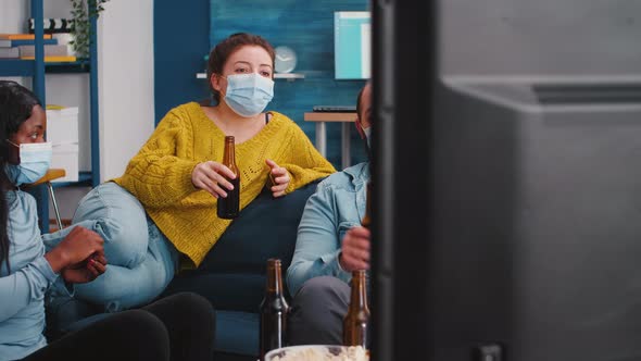 Mixed Races People Watching Tv Clinking Bottles of Beer Enjoying Time alt