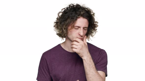 Portrait of Young Sick Man Suffering From Toothache and Touching Jawbone with Pain on Face Over alt