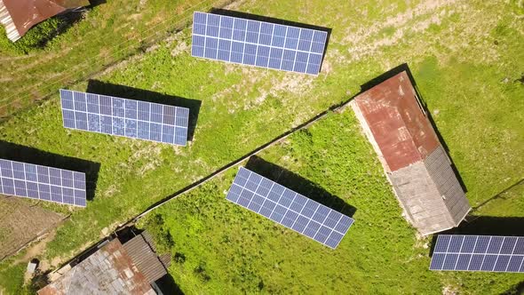 Aerial top down view of solar panels in green rural area. by bilanol