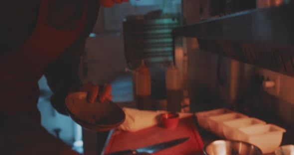 Close up of the chef doing final adjustment on the plate alt