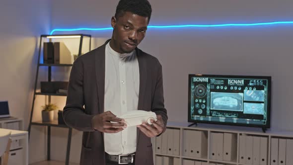 African-American Engineer Posing with Car Model alt