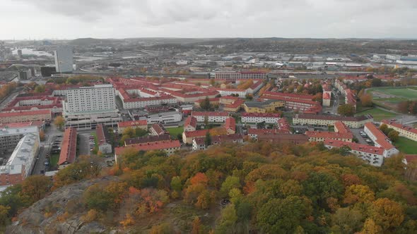 Autumn Foliage Forest on Hill Gamlestaden Gothenburg Aerial Reveal