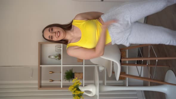 Vertical video of dancing teen girl wearing a yellow body top dancing
