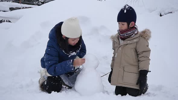 Cute Asian Children Playing On Snow In The Park Together , Aomori Japan  alt