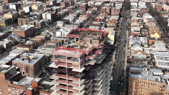 A high angle view above a new high-rise construction site in Brooklyn, NY. The drone camera zoom in, alt