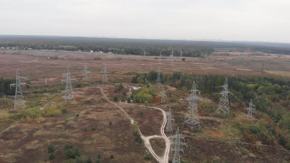 High voltage power pylons. Tower of power lines in the forest. Electric tower lines. Green energy alt