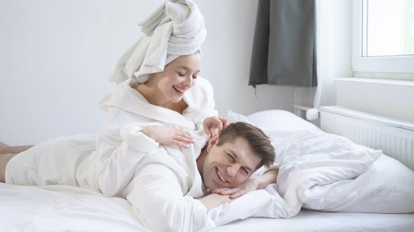 Funny Young Caucasian Couple Lying Together After Bathroom Shower Enjoy Weekends