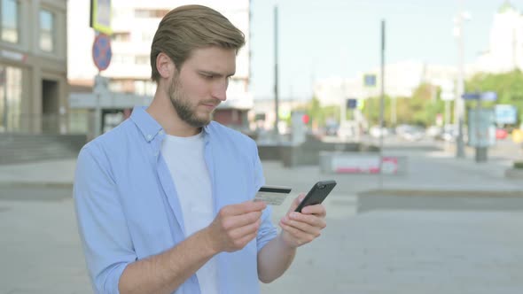 Excited Man Shopping Online Via Smartphone Outdoor alt