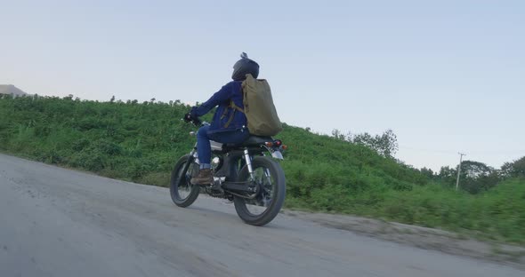 Male Biker Driving A Vintage Motorcycle alt