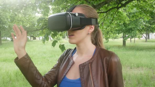 Woman Uses A Modern Virtual Reality Helmet In The Park