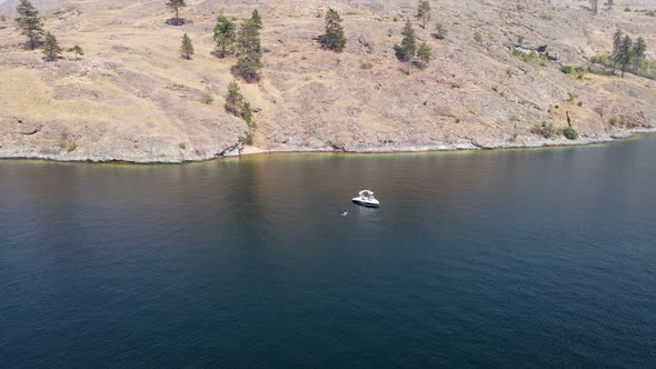 Young woman taking a bath in deep blue Okanagan Lake during a hot summer day in Canada. Fast approac alt