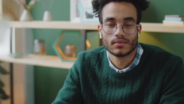 Portrait of Young Handsome Man Wireless Earphones in Office alt