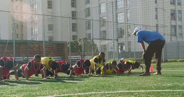 Soccer kids exercising in a sunny day alt
