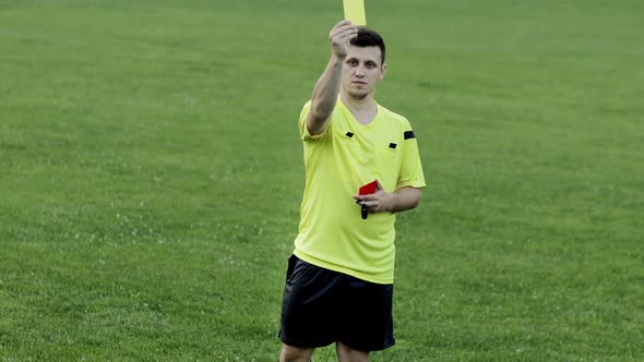 Soccer referee shows yellow card . Concept of sport, rules violation, offside. alt