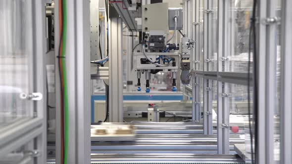 Handling Robot Carries Plastic Product To Conveyor At Factory