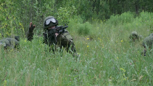 Soldiers in Camouflage with Assault Rifles Out of the Ambush in the Field Military Action alt