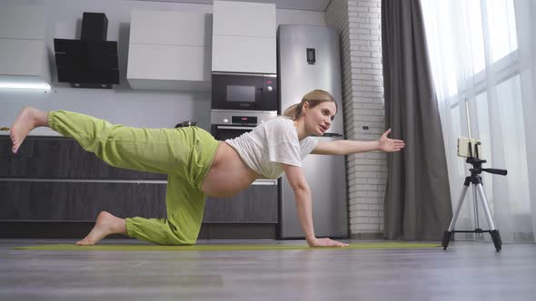 Pregnant Woman Stretching and Training at Home Recording on Smartphone Pregnant Woman Doing Yoga