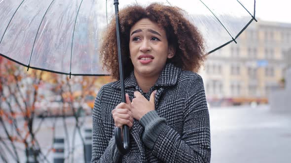 African American Girl Curlyhaired Sad Woman in Stylish Coat Stands in Autumn on City Street with alt