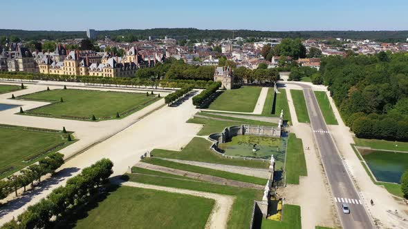 Aerial View of Medieval Landmark Royal Hunting Castle Fontainbleau and Lake with White Swans, France