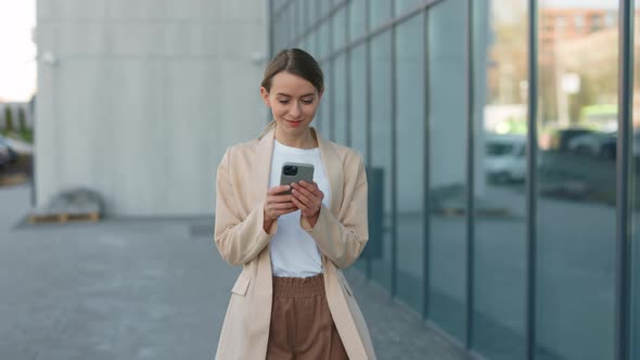 Businesswoman Working with Modern Smartphone Outdoors alt
