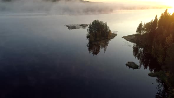Finland, Wonderful Sunrise on Misty Lake in the Morning, Flying Above Lake Water, Trees Reflecting alt