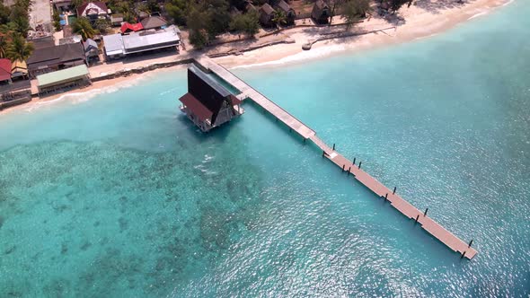 Aerial top down shot of beautiful Gili Meno Island with turquoise clear water and wooden footbridge alt