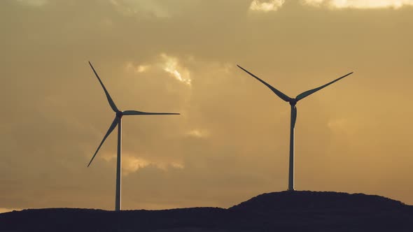 group of windmills for renewable electric energy production. Production of green energy with wind alt