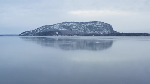 Ice formed on surface of Moosehead Lake with Mount Kineo Aerial alt