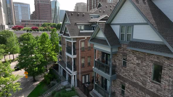 Close-up aerial approach of residential apartment building in urban city. Balcony view. alt