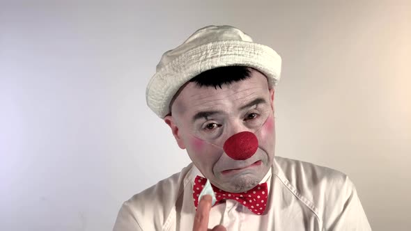 Emoji Clown - Crying Face. A mime clown sad with a lot of tears running from one eye, down the cheek alt