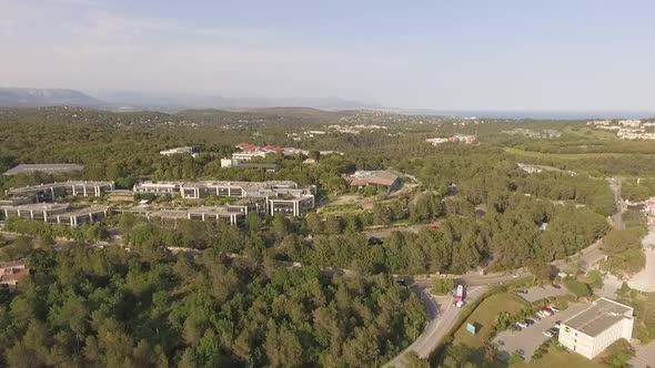 Aerial View of Green Valley with Small Road and Big Villas in South of France alt
