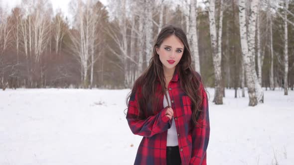 Charming Female with Long Hair Walking in Snowy Forest