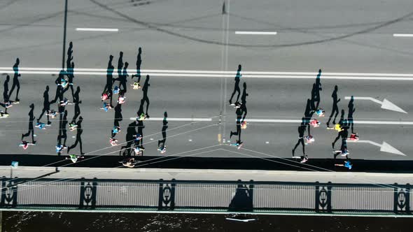 Aerial view of the city marathon, a crowd of people running through the ...