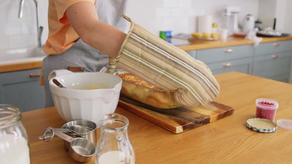 Woman Cooking Food and Baking on Kitchen at Home alt