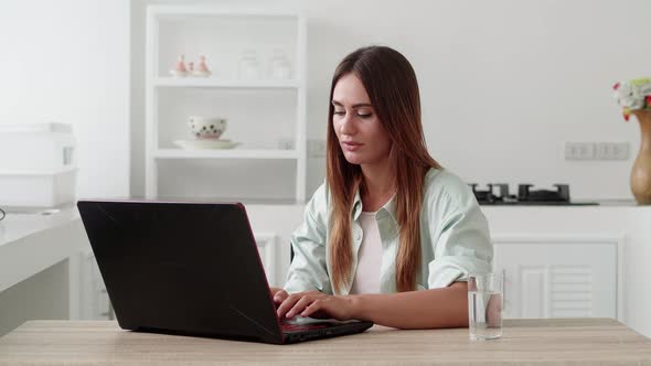 Young Woman Customer Celebrating Winning Bid or Getting Ecommerce Shopping Offer on Laptop alt