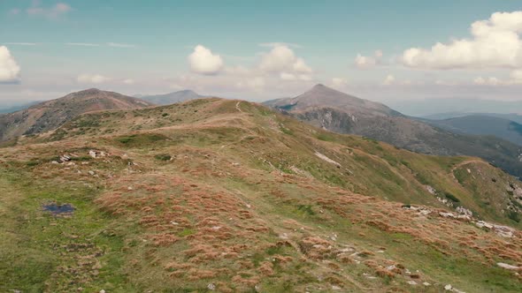Beautiful Green Mountain Peaks Under Cloudy Sky alt