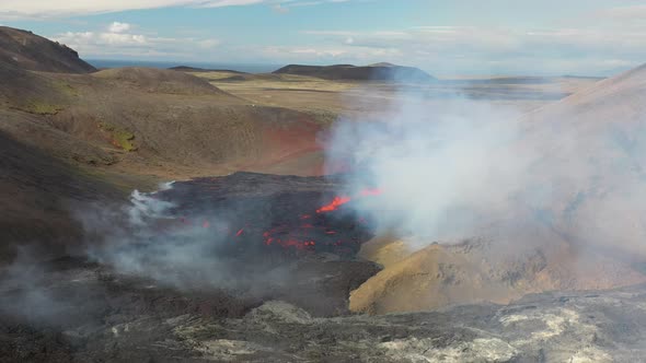 Erupting Volcano Scenery In Volcanic Crater With White Smoke Plume Coming From Glowing Hot Lava In F alt