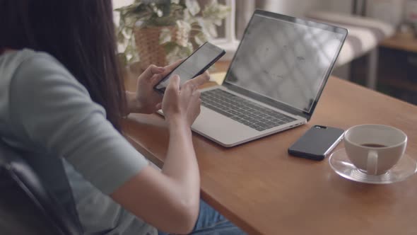 Hands typing mobile phone and scrolls through social media feed in a smartphone.