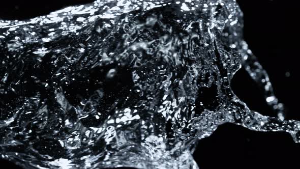 Super Slow Motion Detail Shot of Water Stream Isolated on Black Background at 1000Fps alt