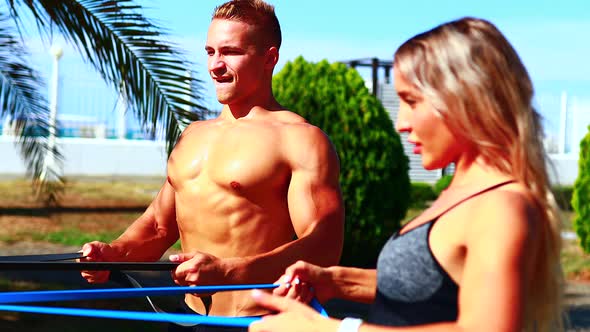 Couple Exercises with a Resistance Band on Hands Biceps Shoulders and Back Muscles Strengthening alt