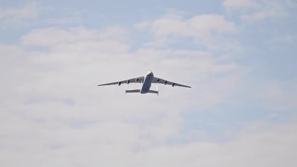 The Biggest Plane on Earth Flying in the Sky on a Low Altitude with Blue Skies on the Background alt